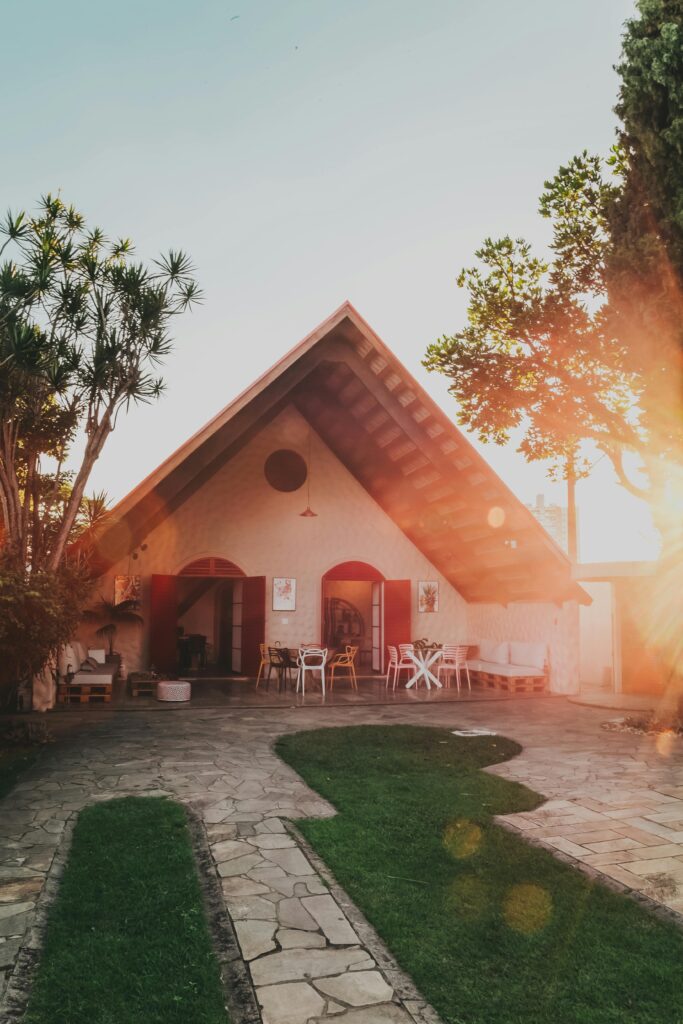 pexels-photo-2980955-2980955 Beautiful A-frame house surrounded by lush garden in warm sunlight, creating a serene and inviting atmosphere.